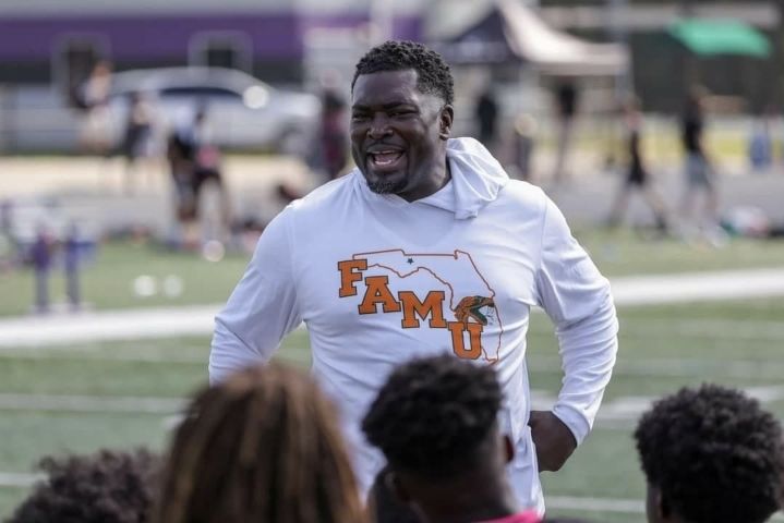 Coach BoJack in FAMU hoodie speaking to youth on track