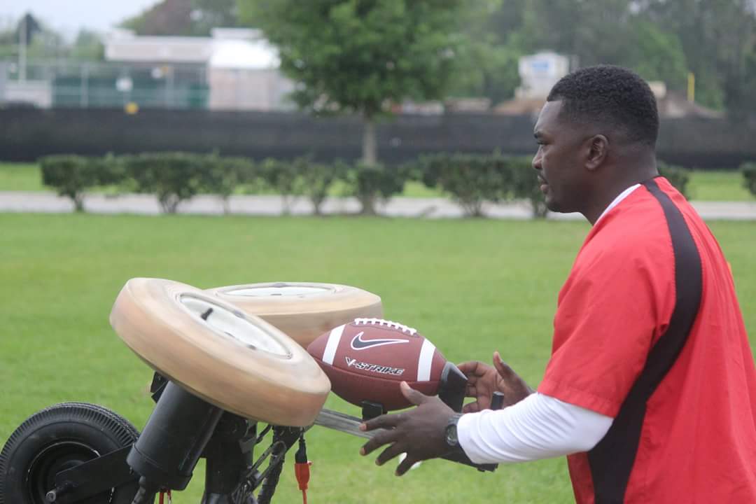 Coach BoJack loading football into passing machine
